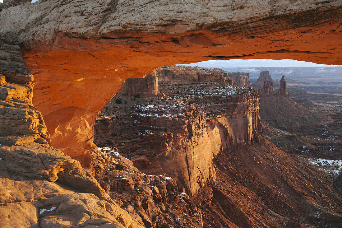 Landscape through Mesa Arch at sunrise in winter, Canyonlands National Park, Moab, Utah, USA