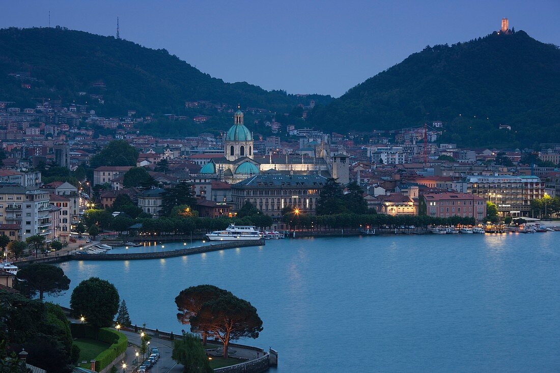 Italy, Lombardy, Lakes Region, Lake Como, Como, city view from Bellagio road, dusk