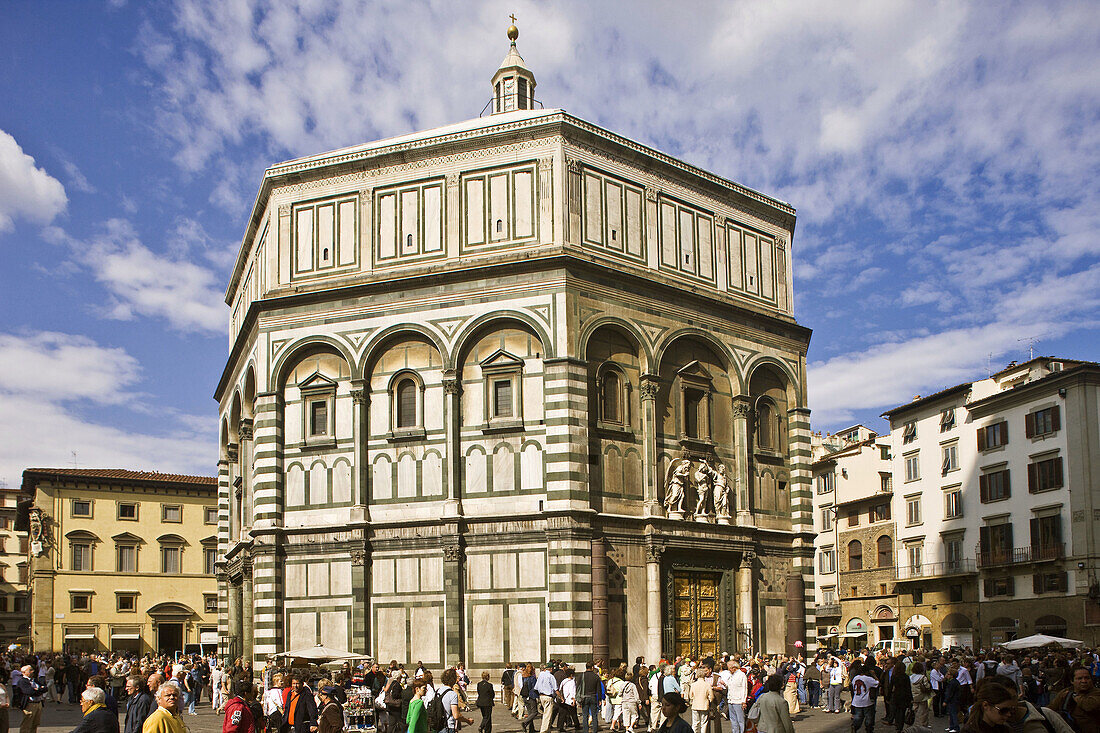 Tourists near the Gates of Paradise by Lorenzo Ghiberti of the St John´s Baptistery, Florence. Tuscany, Italy