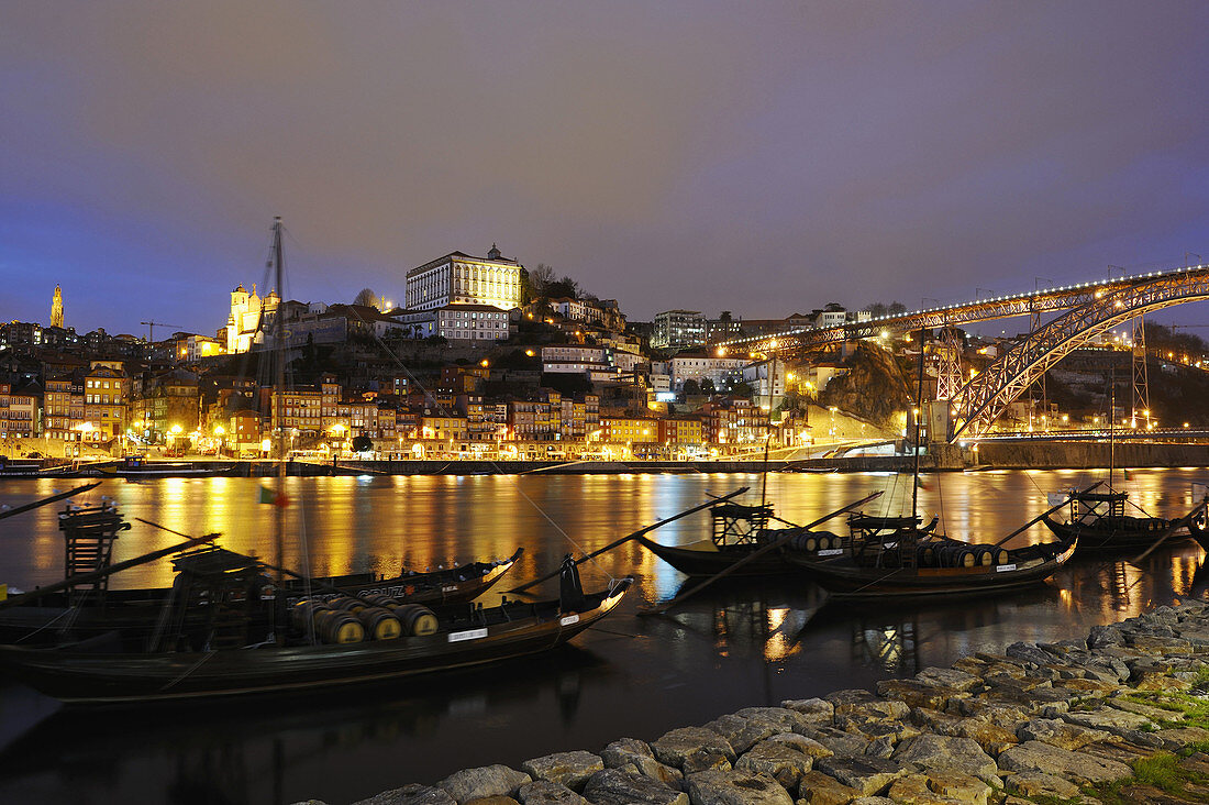 Rabelos ancient boats for porto wine transport in front of cellars at Vila Nova De Gaia along Douro River near Dom Luiz I Bridge, Porto. Portugal