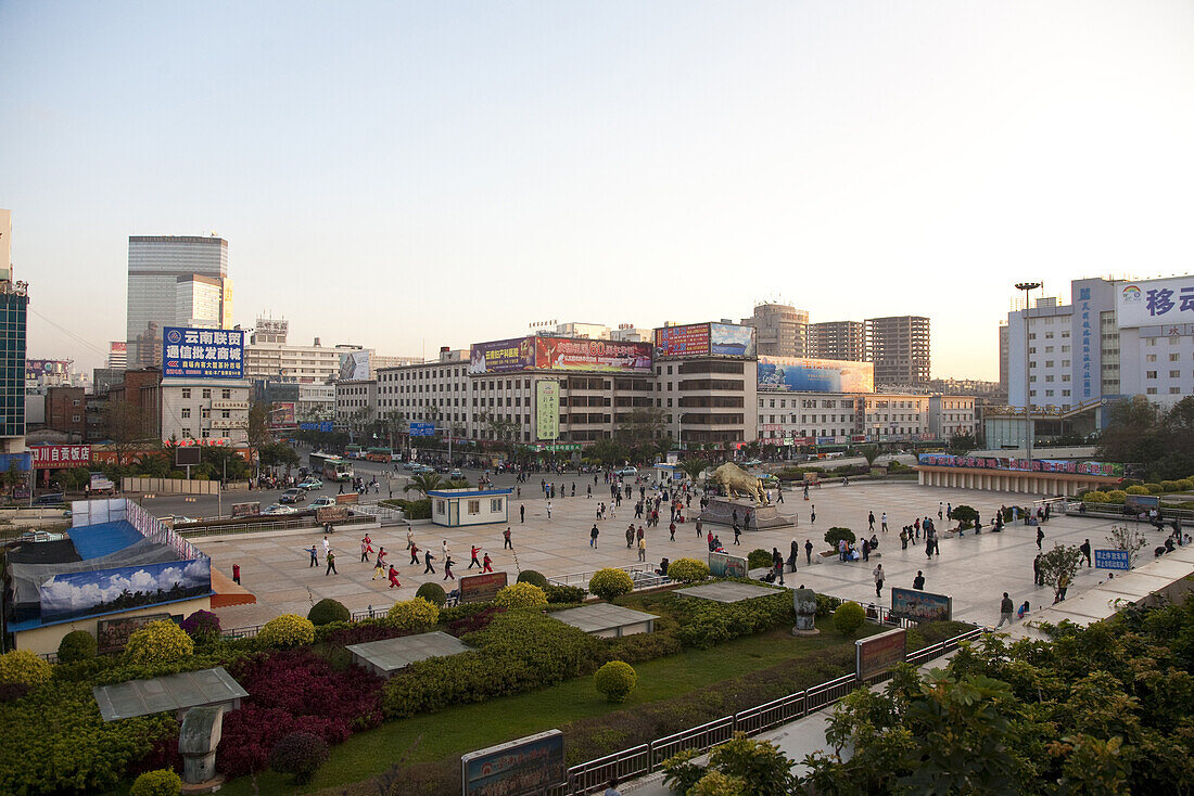 People on a square at the station at the city center of Kunming, Yunnan, People's Republic of China, Asia