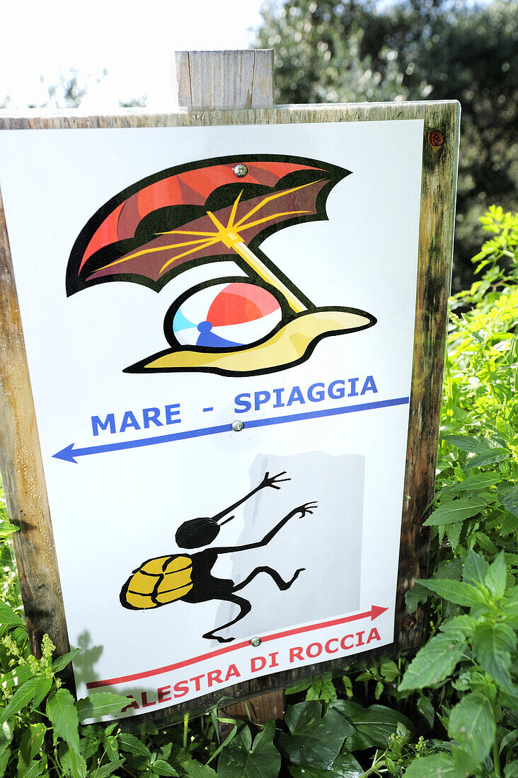 Sign post with pictogram of beach and climbing area, Liguria, Italy