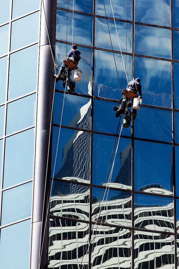Window cleaner cleaning the outside of a skyscaper building, Chicago, Illinois, USA