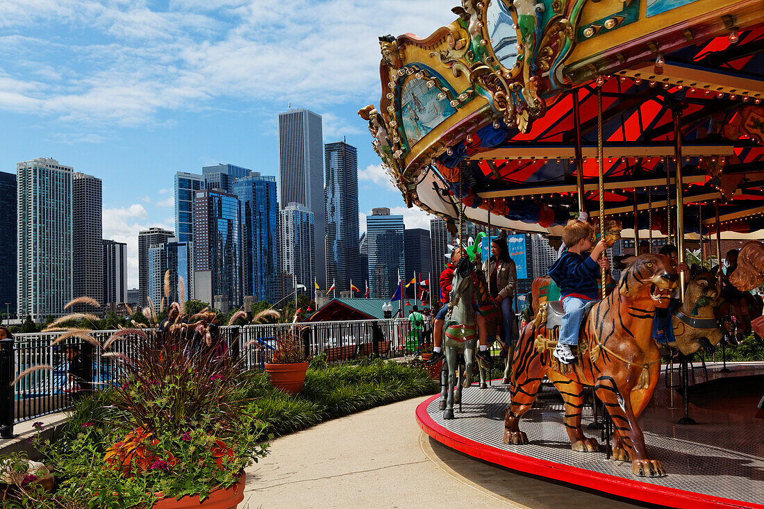Carousel on Navy Pier and the skyscrapers of downtown Chicago in the background, Illinois, USA