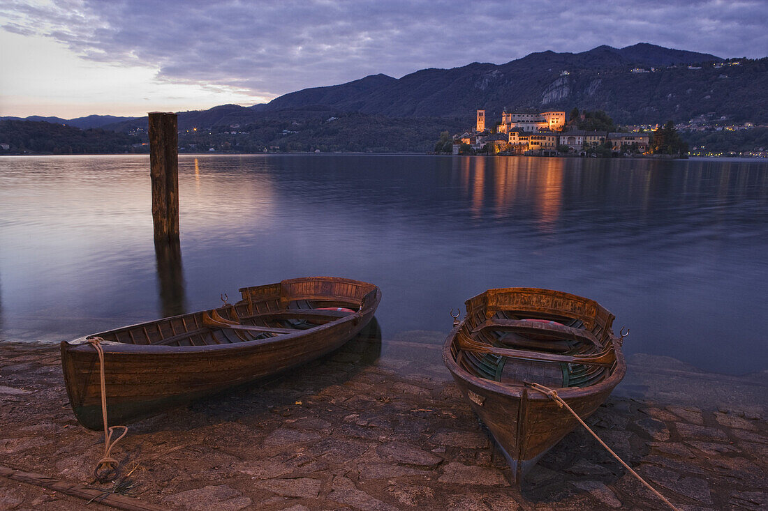 Rowboats at the lakefront of Lake Orta, in the background Isola San Giulio, Orta San Giulio, Piedmont, Italy