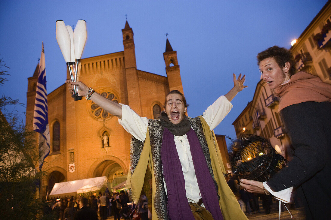Juggler in front of the cathedral during the festival, Piazza Risorgimento, Palio di Alba, Alba, Piedmont, Italy