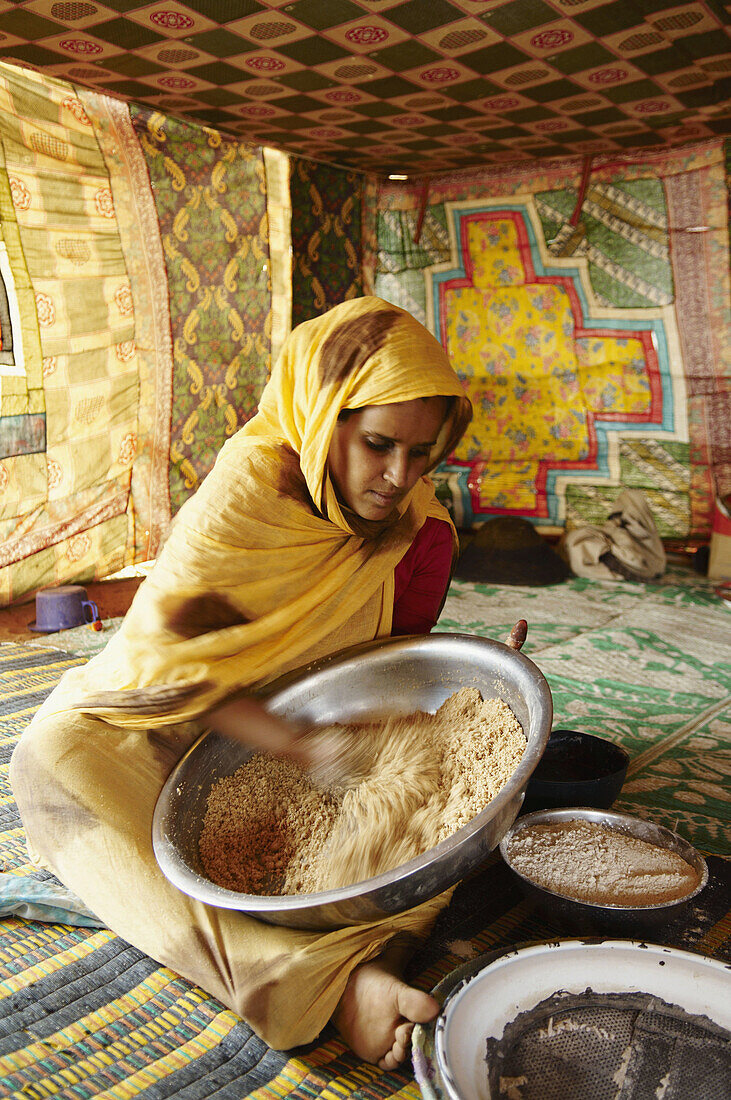 Woman preparing couscous, Chinguetti. Adrar Plateau, Sahara Desert, Mauritania