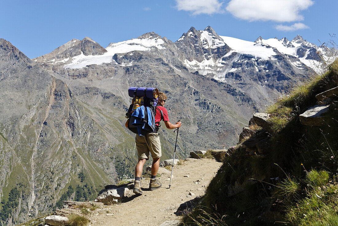 Hiker ascenting to mountain hut Rifugio Vittorio Sella, Alta Via Aosta, Gran Paradiso National Park, Aosta valley, Italy