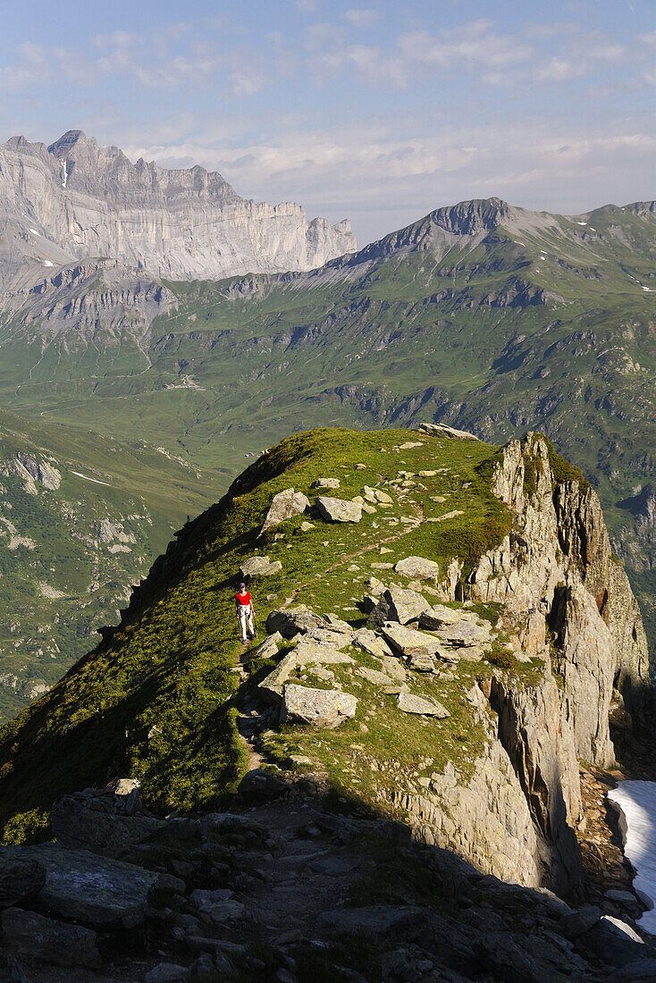 Woman hiking through Diosaz valley, Rochers de Fiz in background, Haute Savoie, Rhone-Alpes, France