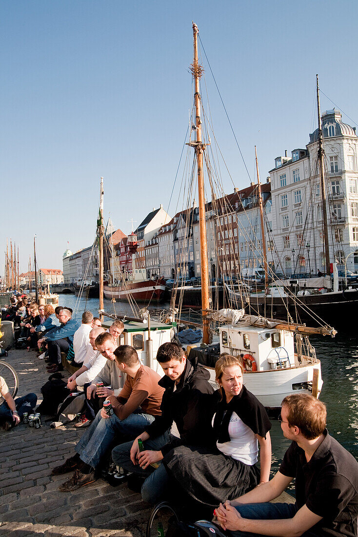 People outside a bar at Nyhavn Canal, Copenhagen, Denmark