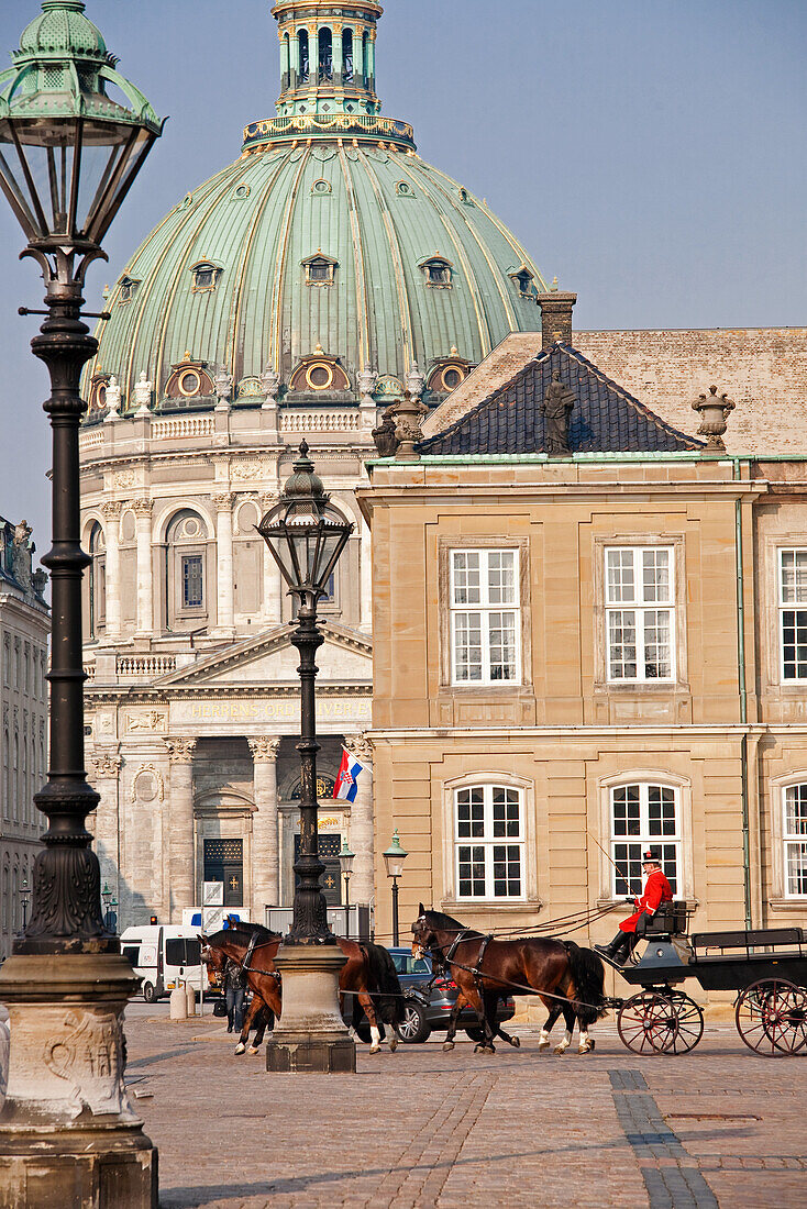Slotsplads courtyard in front of Amalienborg palace with the marble church, Marmorkirken, Frederiks church in the background, Copenhagen, Denmark