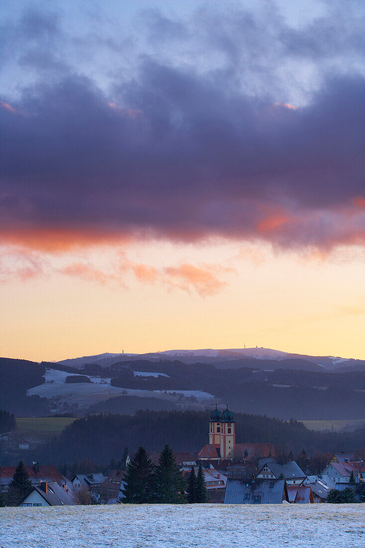 View ot Sankt Margen with monastery in sunset, mount Feldberg in background, Black Forest, Baden-Wurttemberg, Germany
