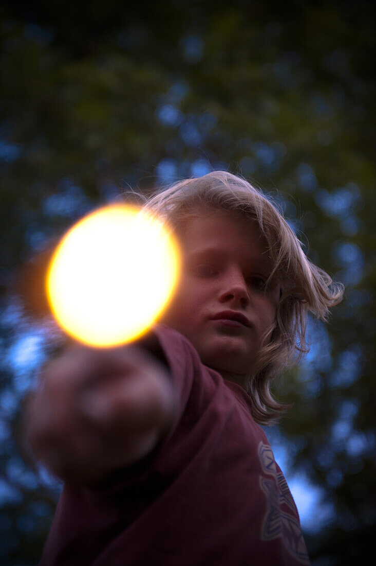 Boy holding a glowing stick, Austria