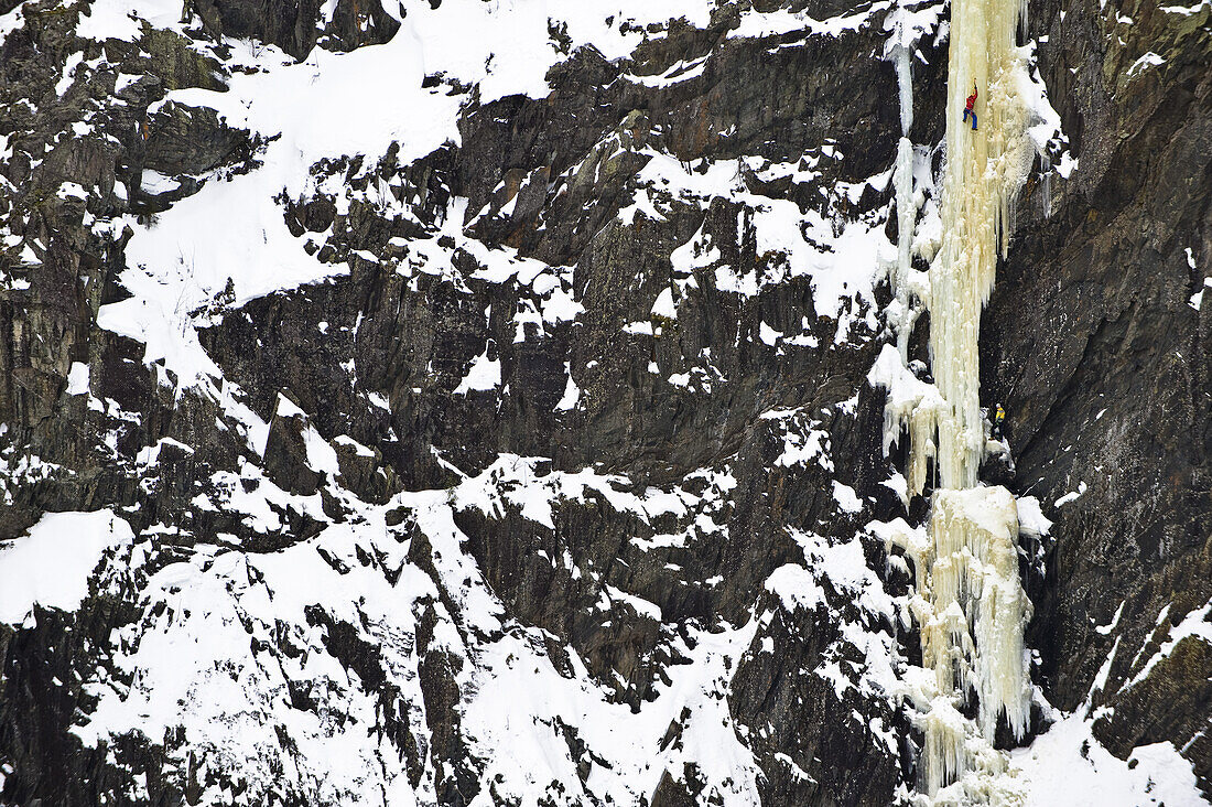 Ice climber in an icefall, Rjukan, Telemark, Norway