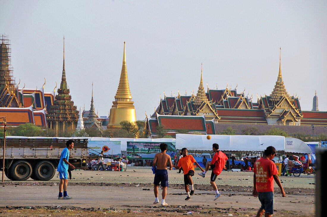 Boys playing football on the esplanade Sanam Luang in front of Wat Phra Kaeo, Bangkok, Thailand, Thailand, Asia