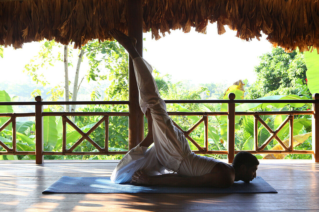 Indian yogi and yoga teacher at the Barefoot at Havelock Resort with a view across the rainforest, Radha Nagar Beach, Beach 7, Havelock Island, Andamans, India