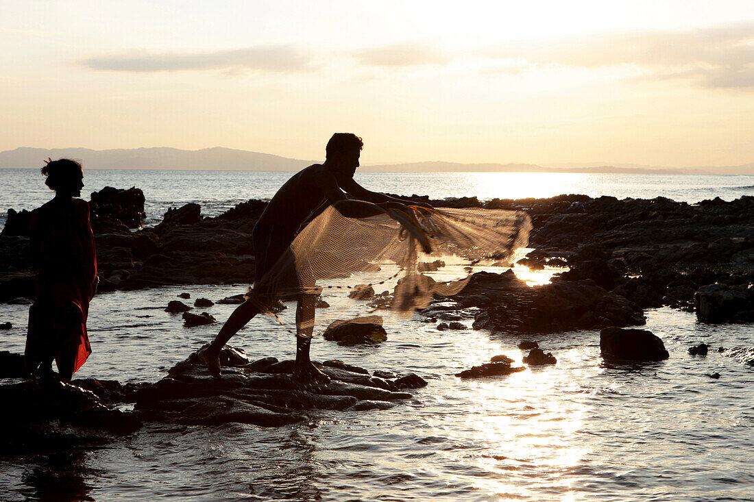 Local couple fishing at Radha Nagar Beach at sunset, Beach 7, Havelock Island, Andamans, India