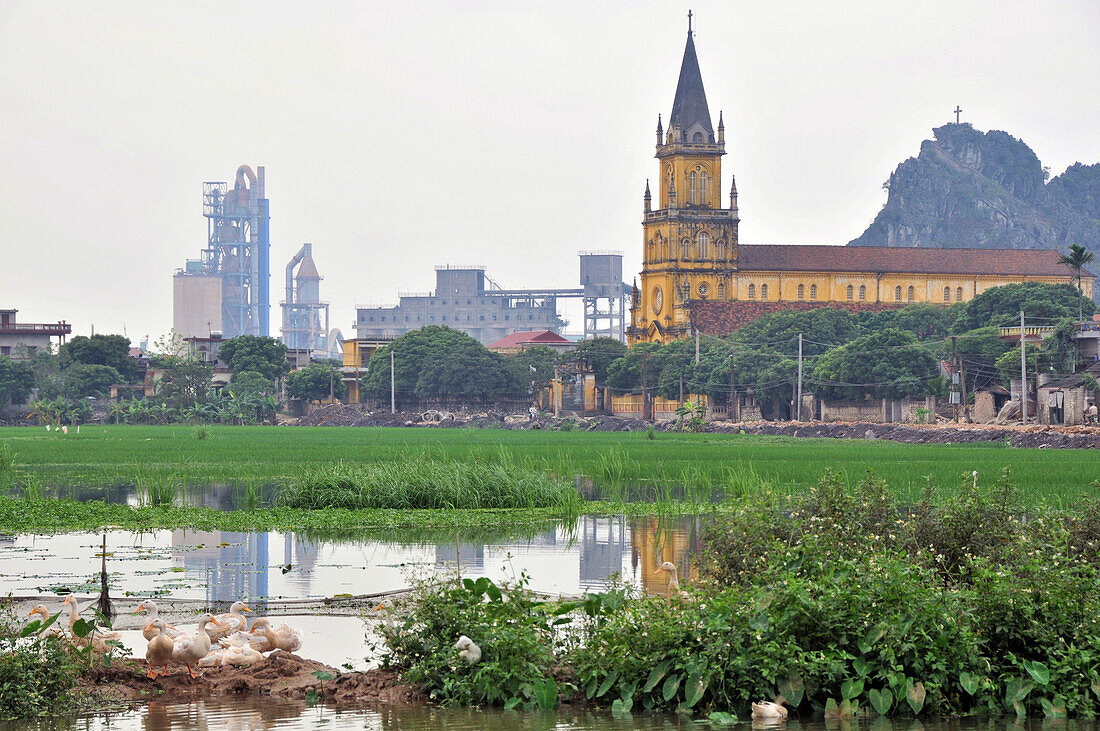 Factory and church in Halong bay near Ninh Binh, north Vietnam, Vietnam