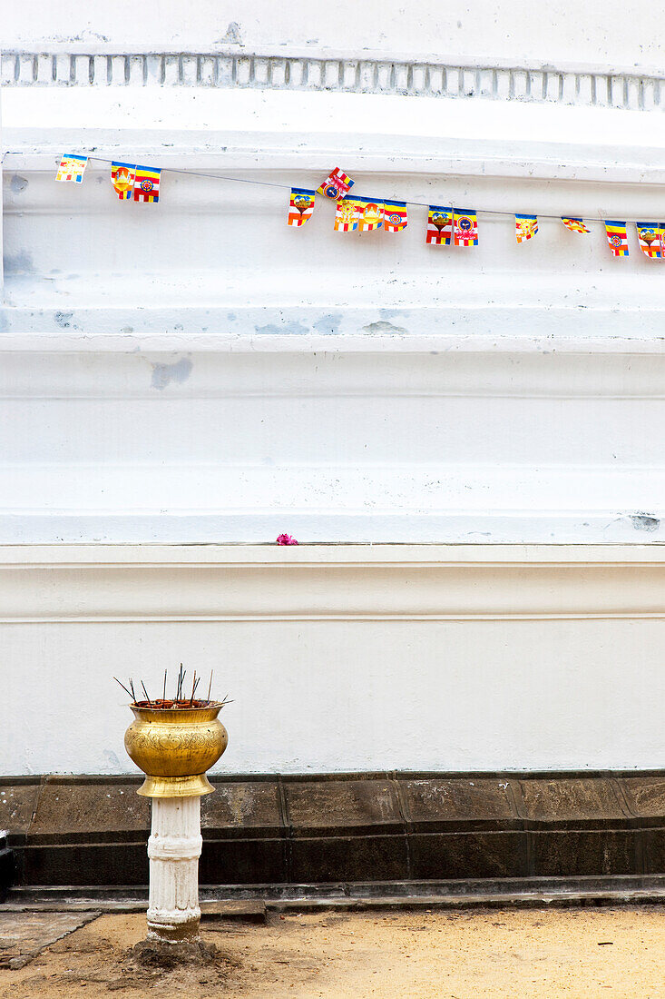 Incense sticks in offering bowl in front of a white stupa at the Kelaniya Raja Maha Vihara temple, Colombo, Sri Lanka, Asia