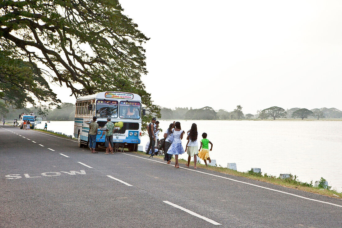 Locals at the Tissa Wewa, an artificial lake from ancient times, Tissamaharama, Sri Lanka, Asia