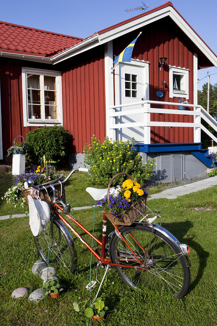 Bicycle in front of a wooden house at Norrfaellsviken, Höga Kusten, Sweden, Europe