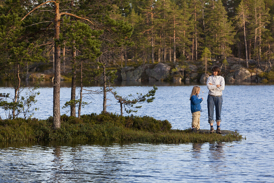A woman and girl at the lake Tärnättvatten at the national park Skuleskogen, Höga Kusten, Vaesternorrland, Sweden, Europe