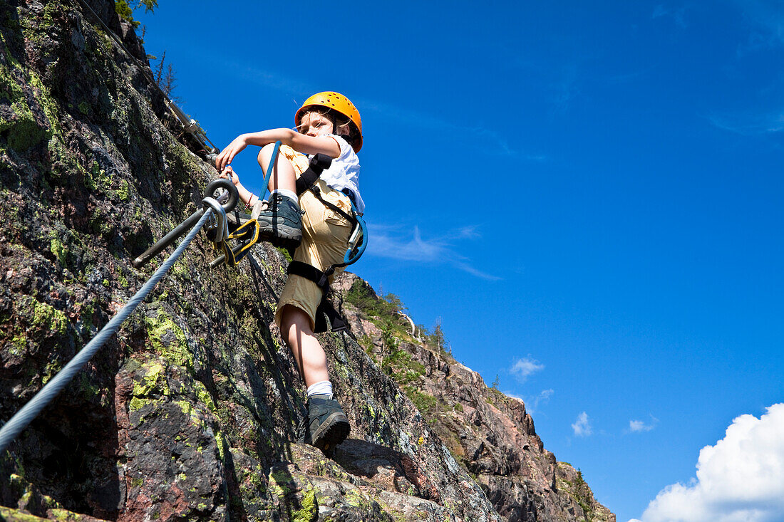 Girl climbing at fixed rope route at Skuleberget, Höga Kusten, Vaesternorrland, Sweden, Europe