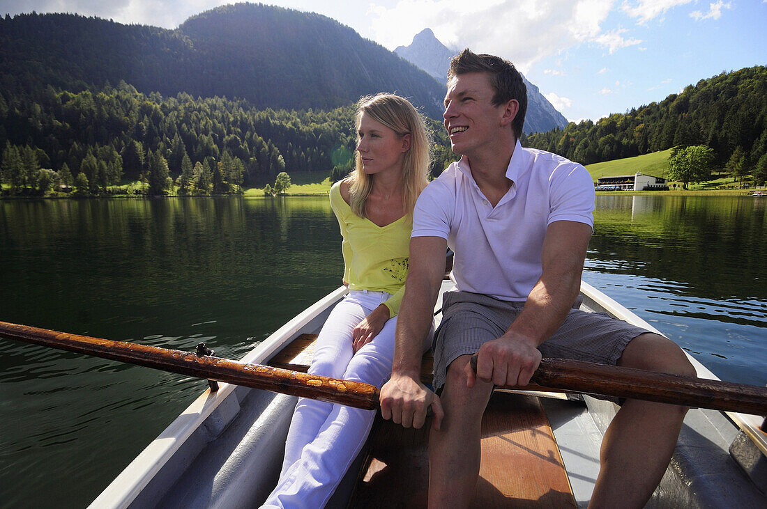 Young couple in rowboat, lake Lautersee, Mittenwald, Werdenfelser Land, Upper Bavaria, Germany