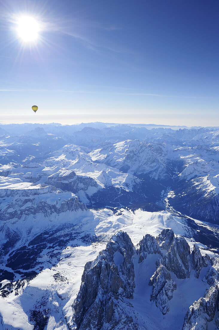 Hot-air balloon flying above Dolomites with Langkofel and Plattkofel in foreground, Sella range, Marmolada range and Pala range in background, aerial photo, Dolomites, South Tyrol, Italy, Europe