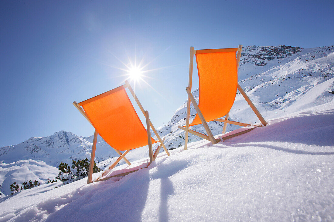 Two deckchairs in snow, Galtuer, Paznaun valley, Tyrol, Austria
