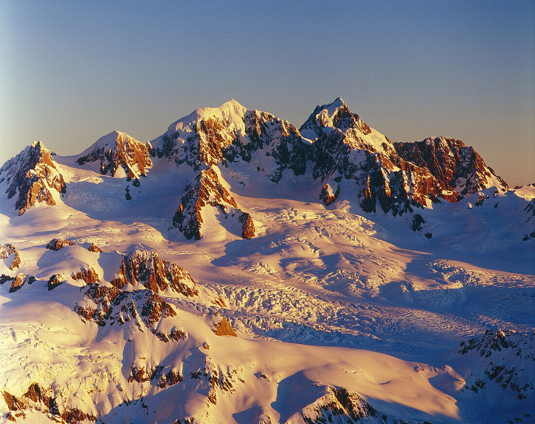 Evening light on Fox neve with Mounts Tasman l and Aoraki/Cook New Zealand