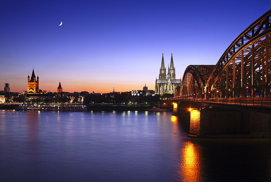 View over river Rhine towards the old town of Cologne and the Groß St Martin church, Cologne cathedral and Hohenzollern Bridge, Cologne, Rhine river, North Rhine-Westphalia, Germany