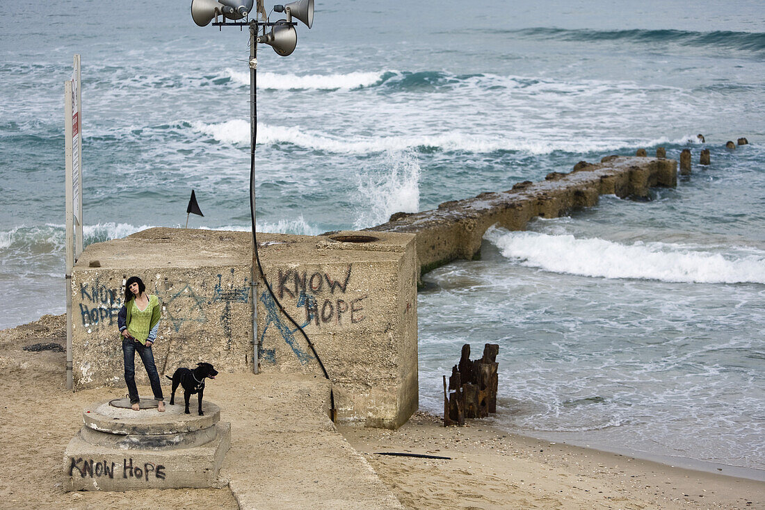 Woman and her dog at the beach, Tel Aviv, Israel, Middle East