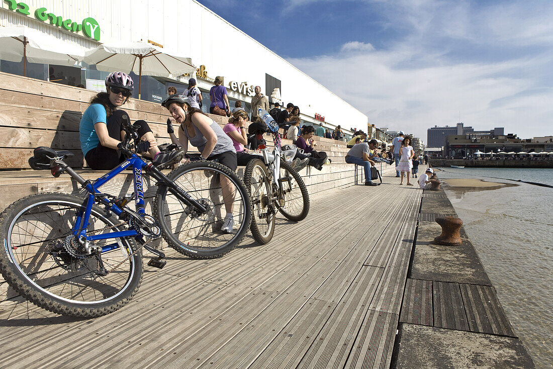 Cyclists take a break at the seaside promenade, Namal section of Tel Aviv, Israel, Middle East