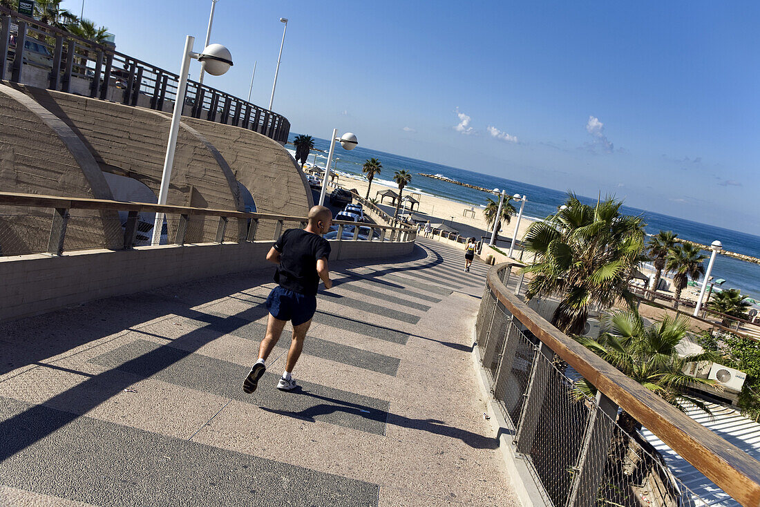 Jogger on the Tayelet seaside promenade, Gordon Beach, Tel Aviv, Israel, Middle East