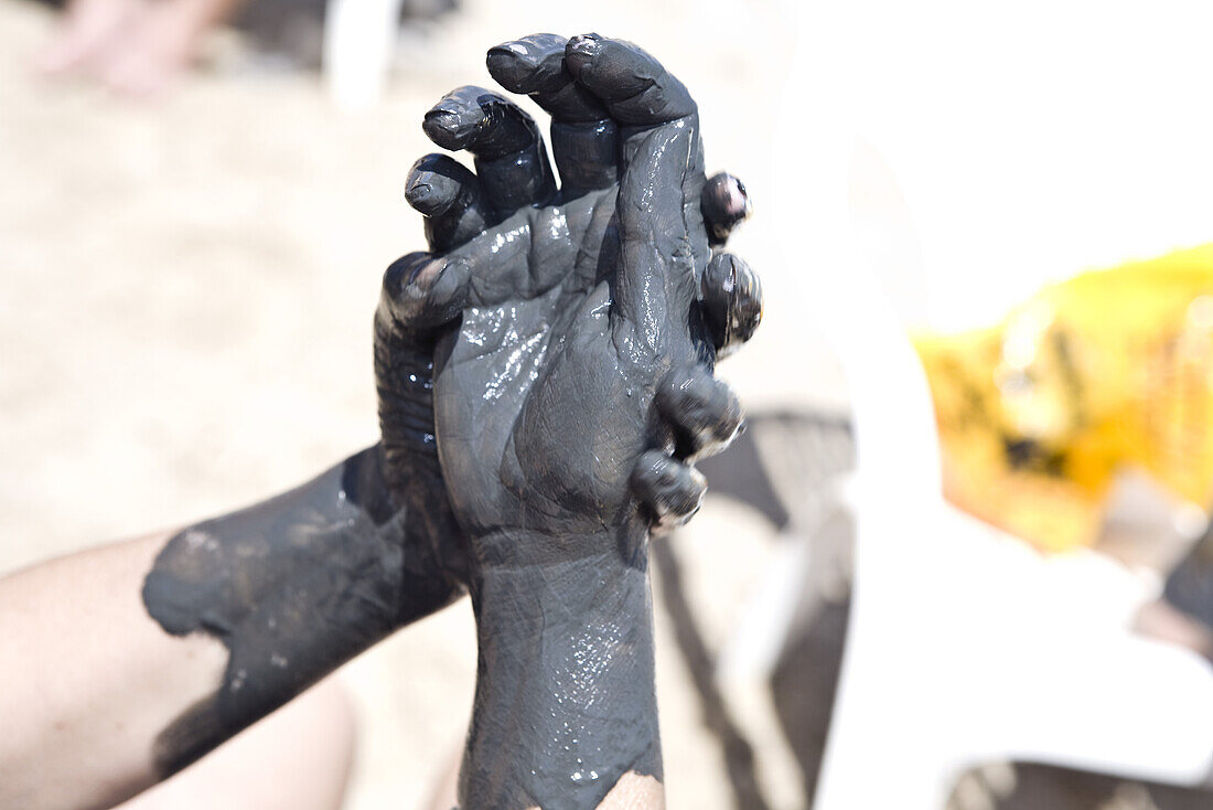 Hands smeared with mineral mud, En Bokek, Israel, Middle East