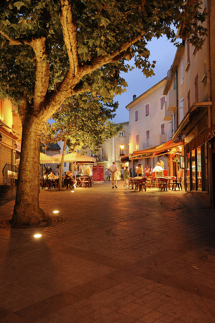 Illuminated street cafes at Greoux les Baines in the evening, Provence, France, Europe