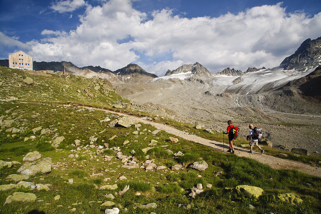 Two hikers near Kesch alpine hut, Albula Range, Canton of Grisons, Switzerland