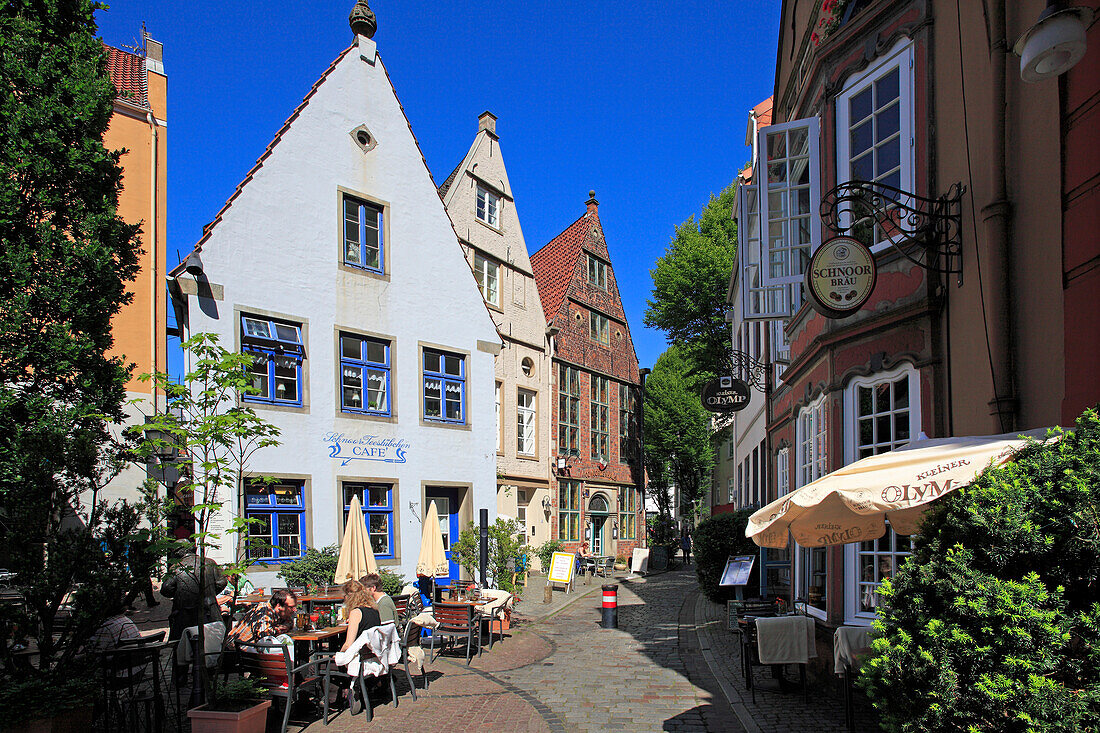 People at street cafe and historical houses at Schnoor quarter, Hanseatic City of Bremen, Germany, Europe