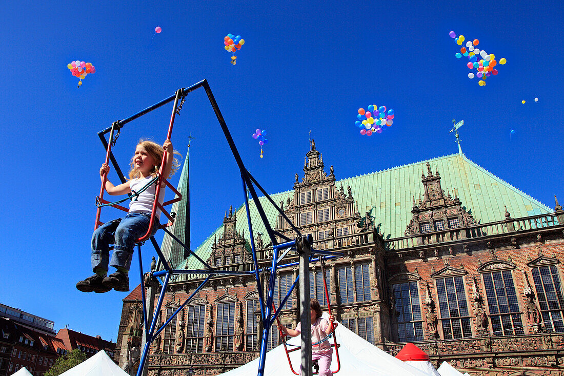 Girl on a swing at children´s party in front of the city hall at the market square, Hanseatic City of Bremen, Germany, Europe