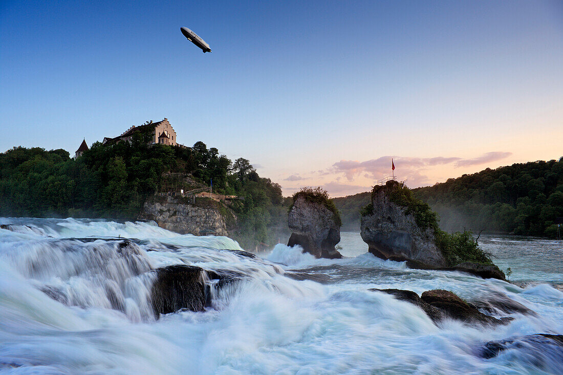 Zeppelin over Rhine Falls near Schaffhausen at dusk, Laufen castle, High Rhine, Canton Schaffhausen, Switzerland, Europe