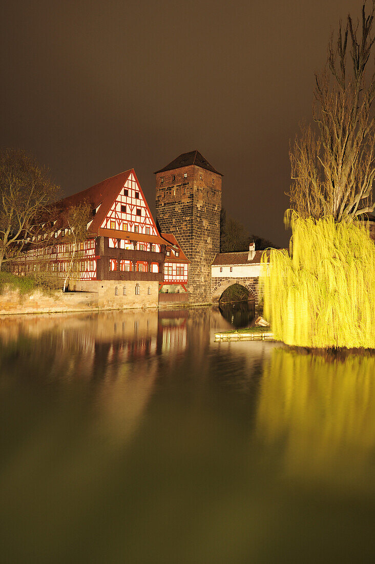 Illuminated Weinstadel, wine store and water tower and the river Pegnitz at night, Nuremberg, Bavaria, Germany
