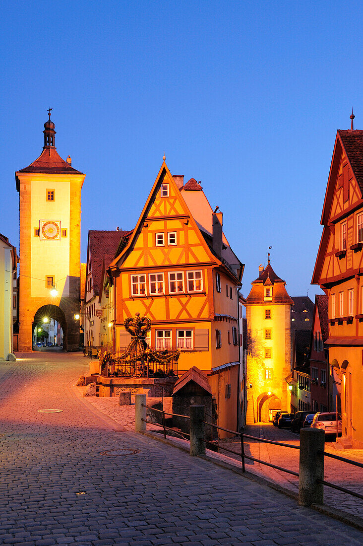 Illuminated Ploenlein with Sieberstor city gate at night, Rothenburg ob der Tauber, Bavaria, Germany