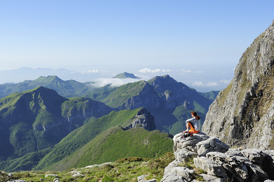 Woman enjoying view over Alpi Apuane, Rifugio Rossi, Pania della Croce, Tuscany, Italy