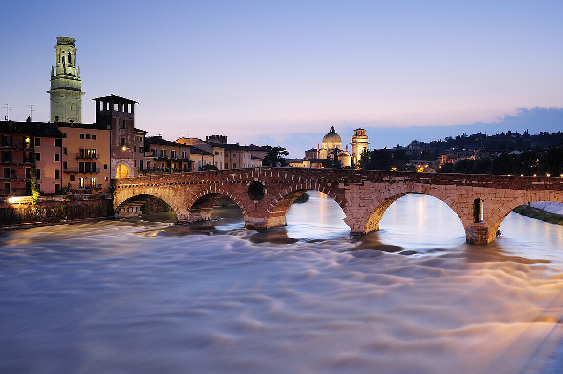 Illuminated bridge Ponte Pietra in the evening light, UNESCO World Heritage Site, Verona, Venetia, Italy