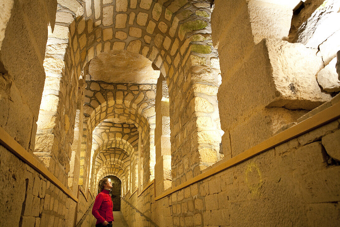 Woman in a corridor of the catacombs of Paris, Les Catacombes de Paris, Paris, France, Europe