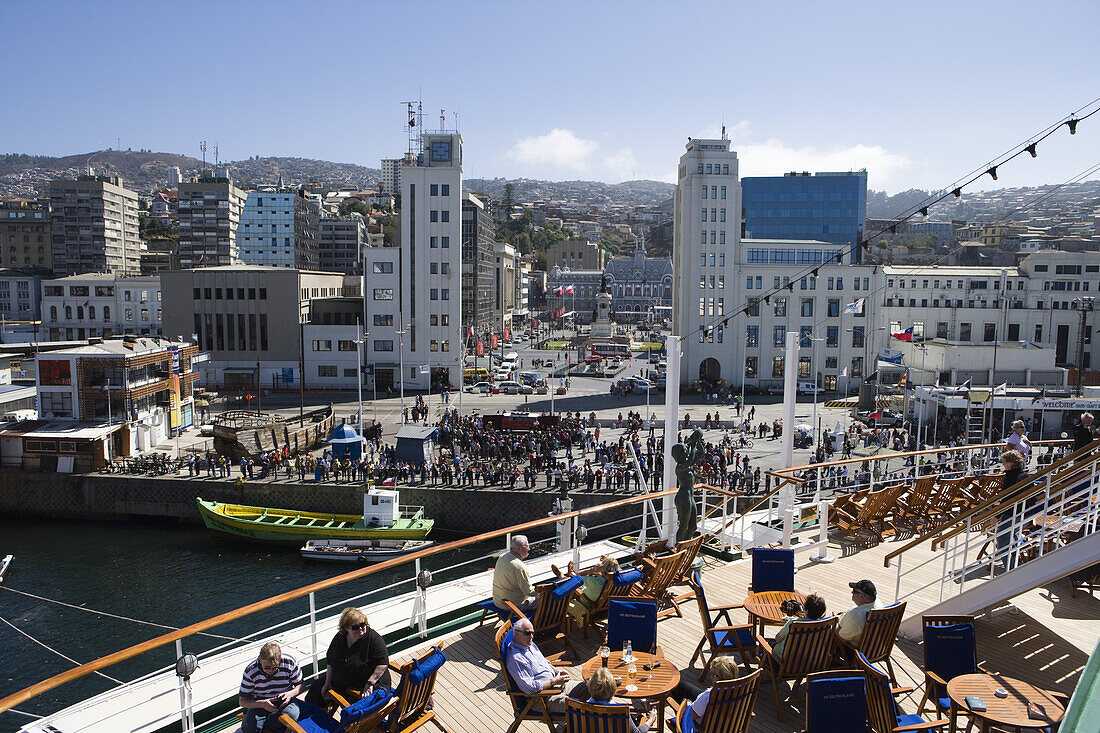 People on deck of cruiseship MS Deutschland (Deilmann Cruises) and view at city as vessel departs, Valparaiso, Chile, South America, America