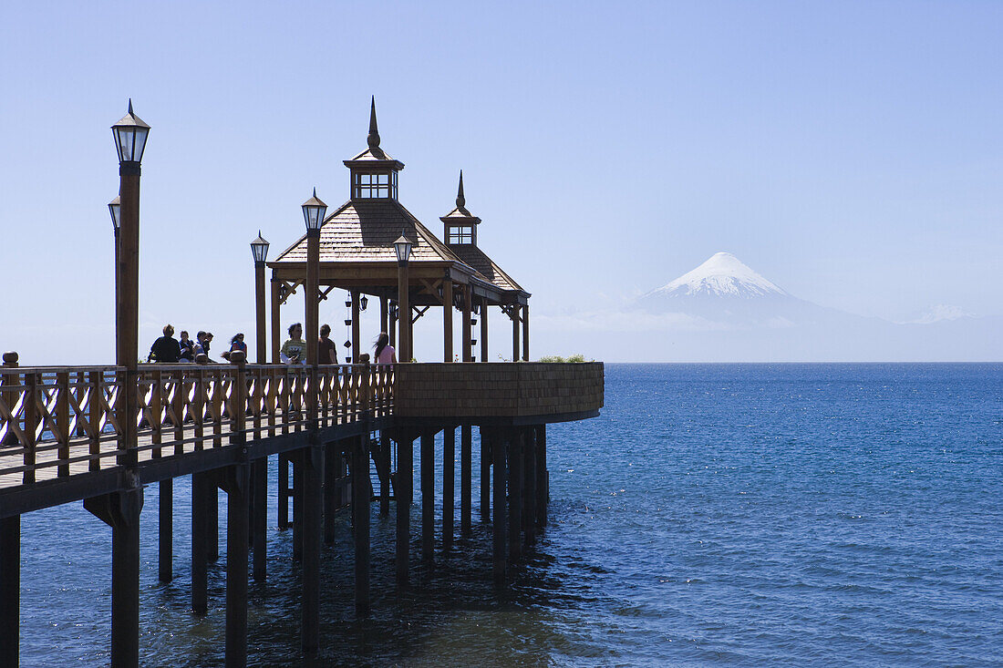 People on pier at Lago Llanquihue lake with view of Osorno Volcano, Frutillar, Los Lagos, Patagonia, Chile, South America, America