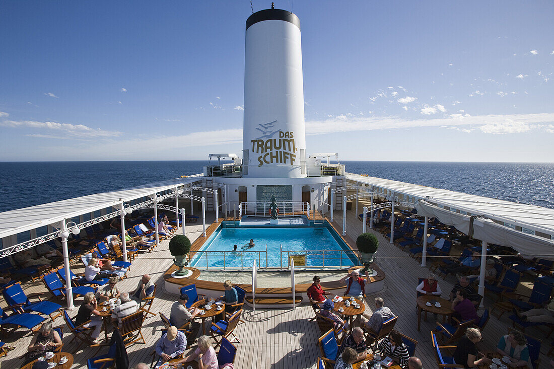 Passagiere genießen Kaffee und Kuchen am Pooldeck von Kreuzfahrtschiff MS Deutschland (Reederei Deilmann), im Südatlantik, Südamerika, Amerika