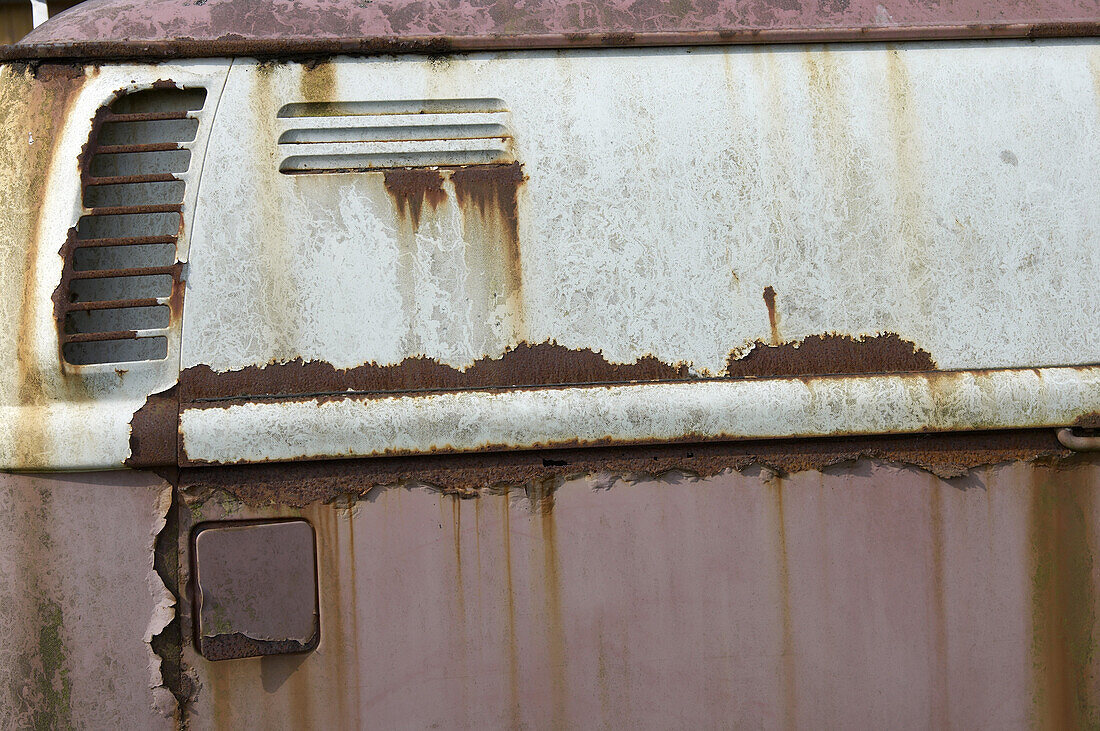 Rust on an old  white and pink car